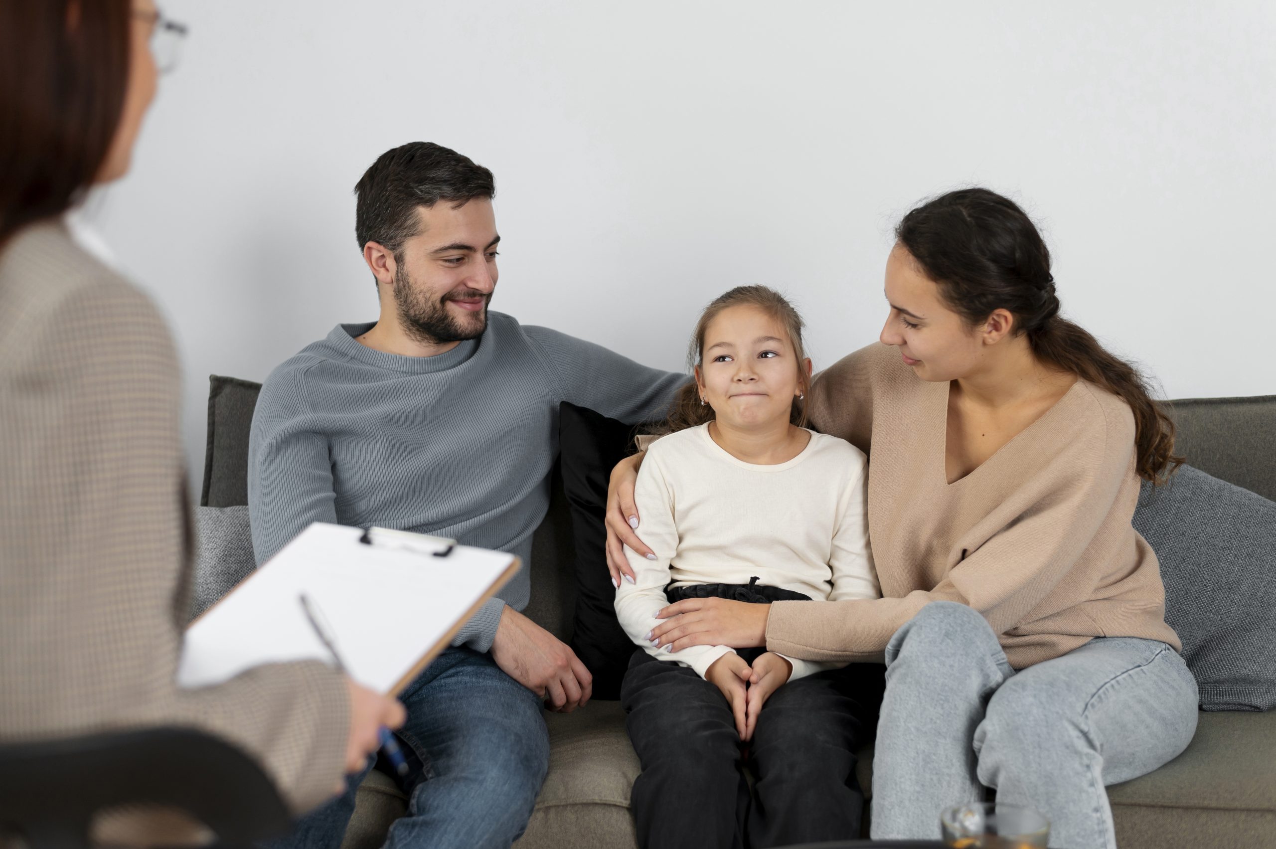 Child therapy session with parents and psychologist, focused on family counseling and emotional support